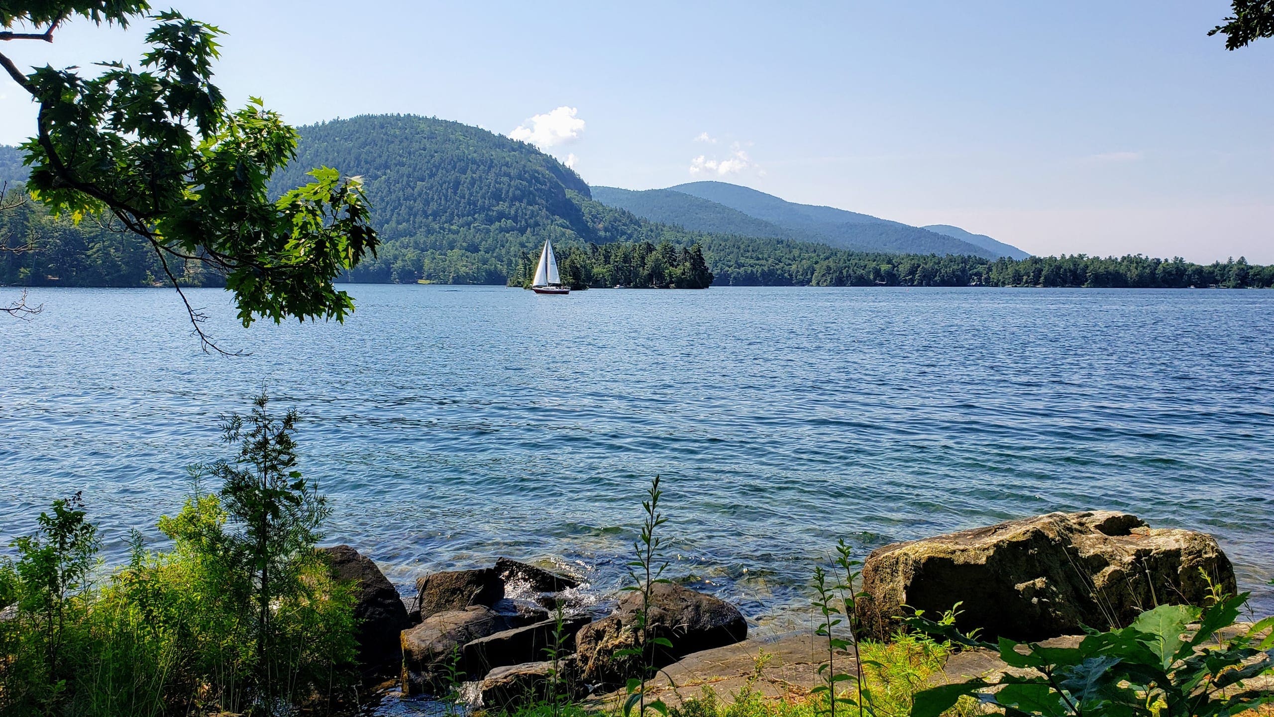 Sailboat sailing on a beautiful sunny day on Lake George, New York