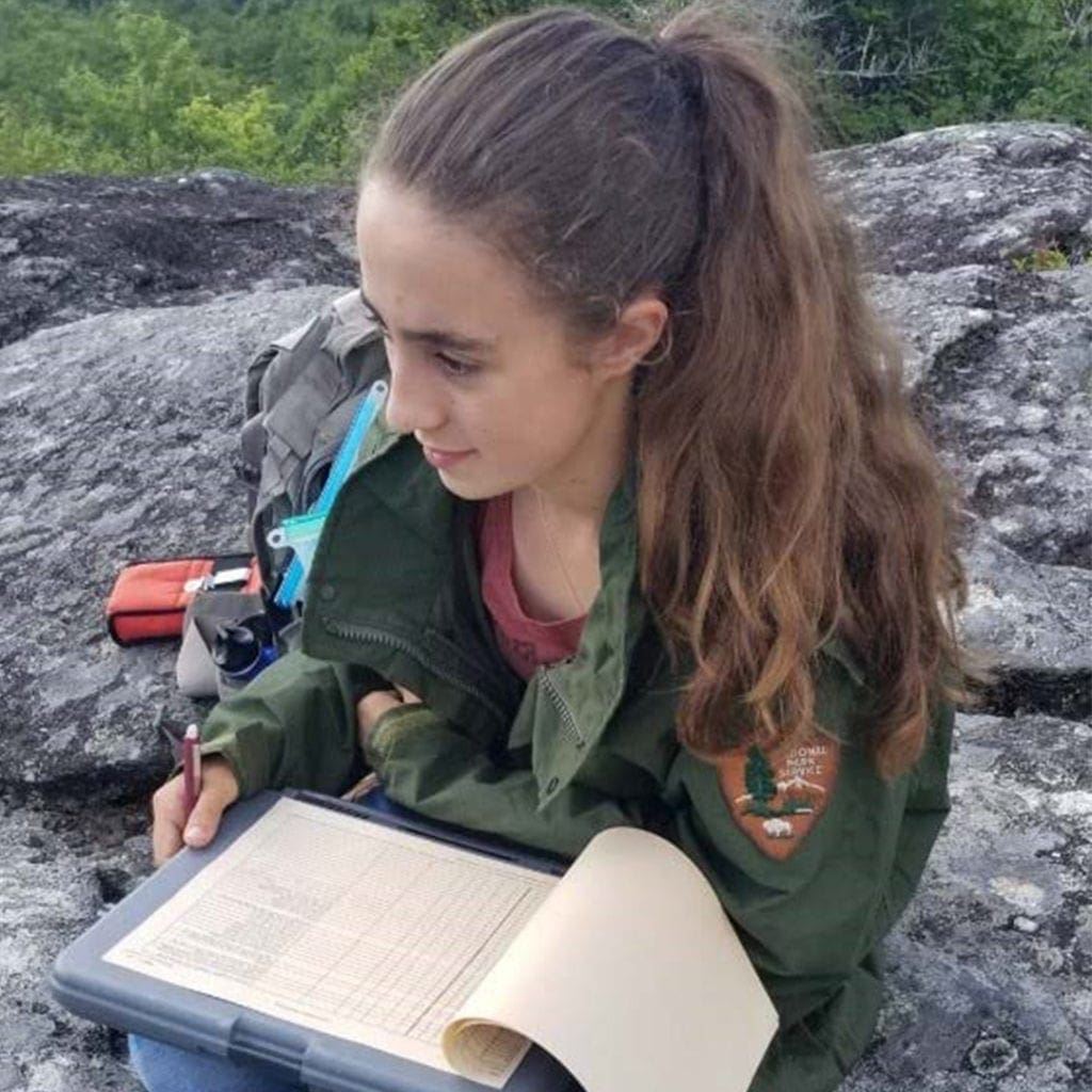 Virginia takes field notes while perched alongside a cliff in the Blue Ridge Parkway - Instagram Photo