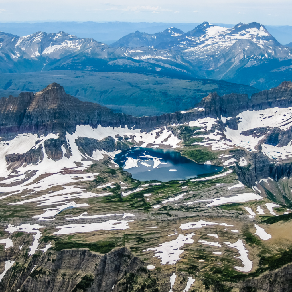 Aerial view of mountain lake and glaciers in Glacier National Park